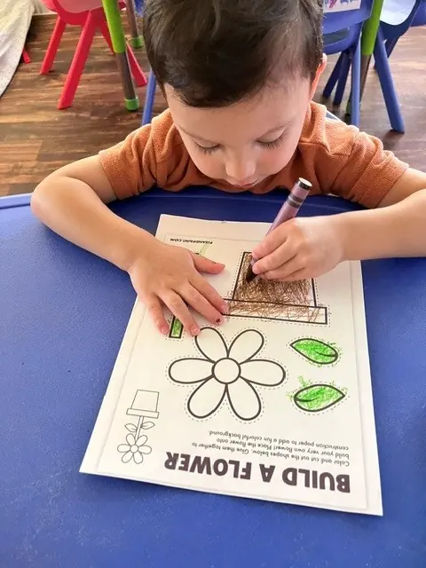 Child completing a build-a-flower learning activity
