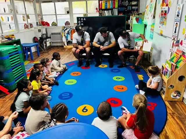 Children gathered for a community-helper classroom visit