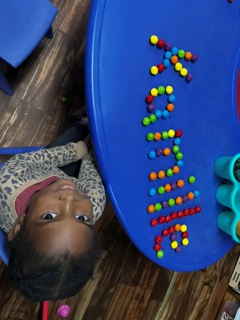 Child practicing early math with colorful counters