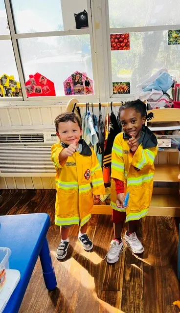 Children enjoying firefighter dress-up dramatic play