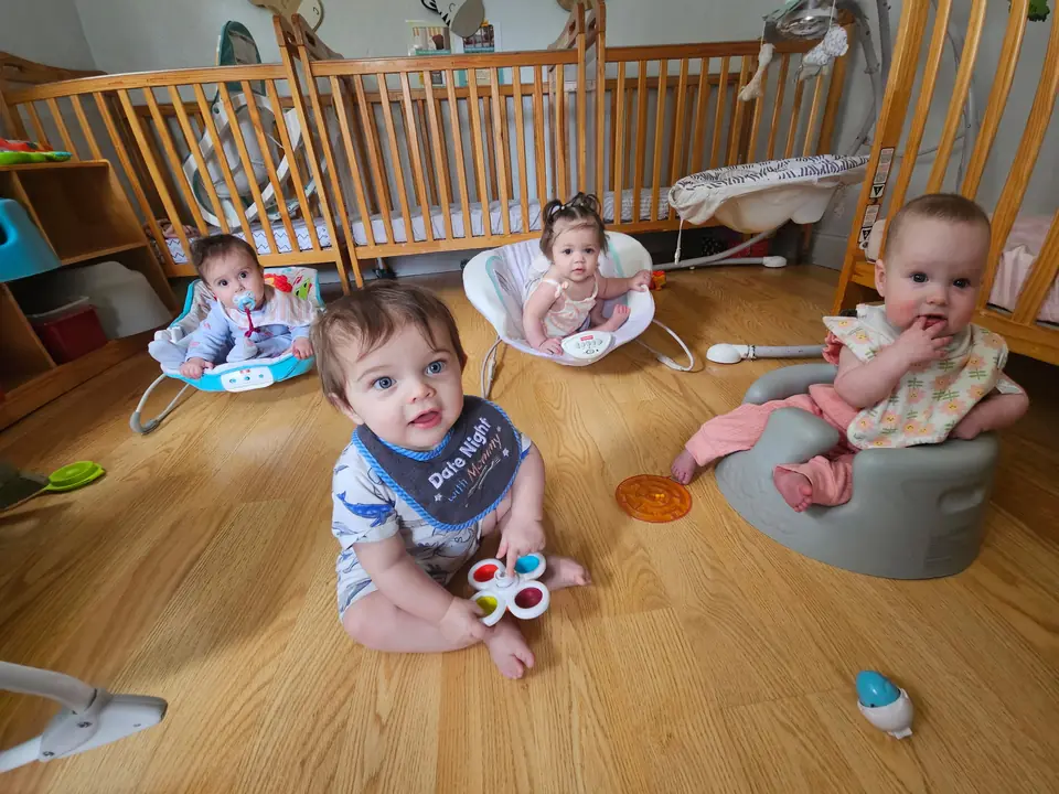 Infants enjoying supervised floor play in the classroom