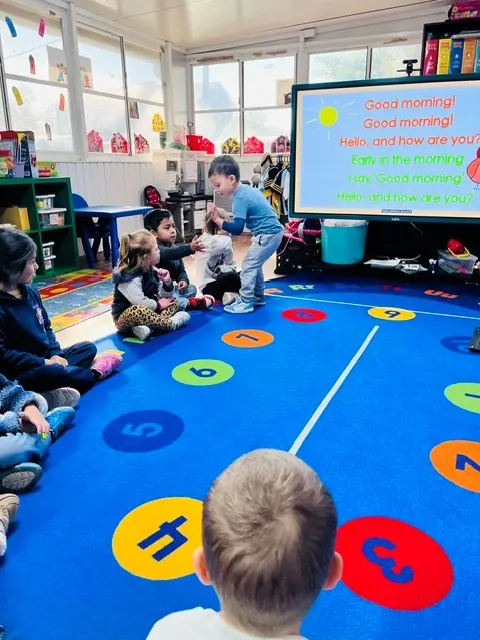 Children gathered for morning circle time and a good-morning activity