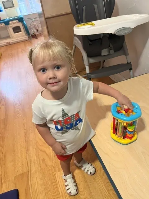 Toddler exploring a bead maze learning toy